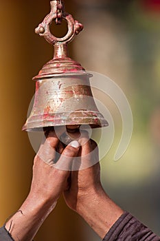 Ringing buddhist bell in nepali temple
