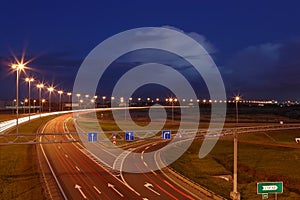 Ringway St Petersburg. Russian road at night, with markings, road signs and lighting masts.