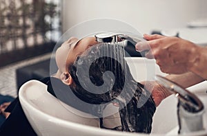 Rinsing makes all the difference. a young girl getting her hair washed at the salon.