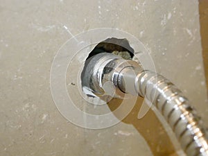 Rinsing spray hose connected to the water pipe, through a metalic joint with female - male thread