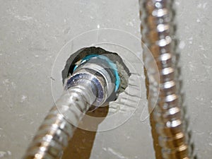 Rinsing spray hose connected to the water pipe, through a metalic joint with female - male thread