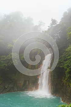 Rio celeste waterfall at foggy day