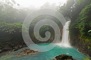 Rio celeste waterfall at foggy day