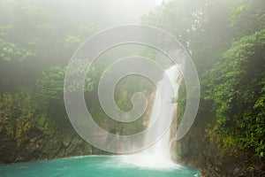 Rio celeste waterfall at foggy day