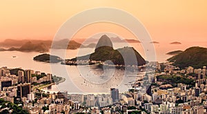 Rio de Janeiro, Brazil. Suggar Loaf and Botafogo beach viewed from Corcovado at sunset photo