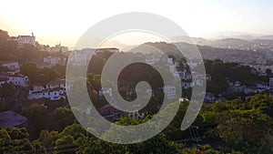 Rio de Janeiro city aerial view video footage. Favelas hills. Sunset backlight. From above.