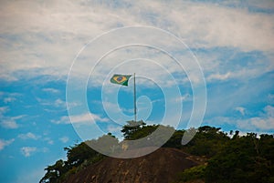 Rio de Janeiro, Lama beach, Brazil: Beautiful landscape with mountain and beach. Flag of Brazil on the mountain