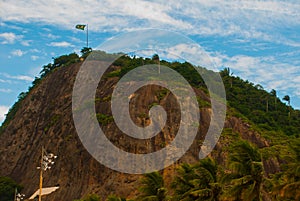 Rio de Janeiro, Lama beach, Brazil: Beautiful landscape with mountain and beach. Flag of Brazil on the mountain photo
