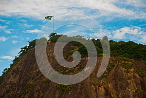 Rio de Janeiro, Lama beach, Brazil: Beautiful landscape with mountain and beach. Flag of Brazil on the mountain photo