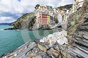 Riomaggiore fisherman village in a dramatic windy weather. Riomaggiore is one of five famous colorful villages of Cinque Terre in