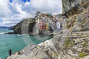 Riomaggiore fisherman village in a dramatic windy weather. Riomaggiore is one of five famous colorful villages of Cinque Terre in