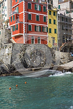 Riomaggiore fisherman village in a dramatic windy weather. Riomaggiore is one of five famous colorful villages of Cinque Terre in