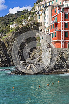 Riomaggiore fisherman village in a dramatic windy weather. Riomaggiore is one of five famous colorful villages of Cinque Terre in