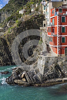 Riomaggiore fisherman village in a dramatic windy weather. Riomaggiore is one of five famous colorful villages of Cinque Terre in