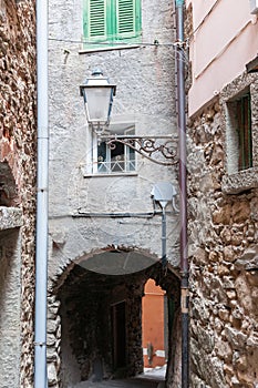 Riomaggiore narrow alleyway with street lamp and arch under home