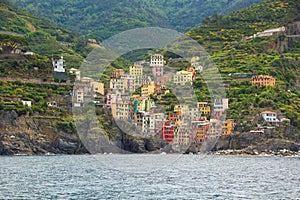 Riomaggiore, one of the five small towns in the Cinque Terre national Park. View from the excursion ship.