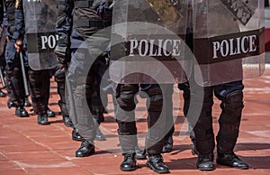 Riot police control the crowd.