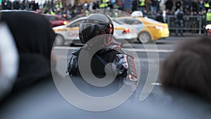 Riot police officers executes law enforcement during political demonstration.