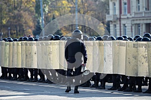 riot police squad with shields and helmets in the streets. police uniform to eliminate outbreaks in public places.