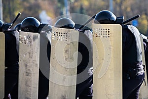 riot police squad with shields and helmets in the streets. police uniform to eliminate outbreaks in public places.