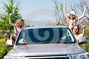 Rioters behind the wheel - female hooligans in the car photo