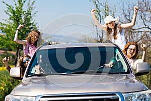 Rioters behind the wheel - female hooligans in the car photo