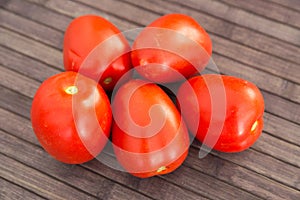 Ripe appetizing san marzano tomatoes on wooden table
