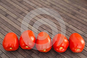 Ripe appetizing san marzano tomatoes on wooden table