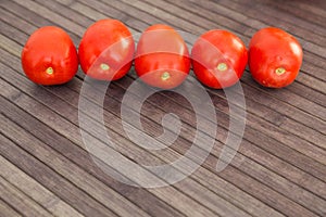 Ripe appetizing san marzano tomatoes on wooden table