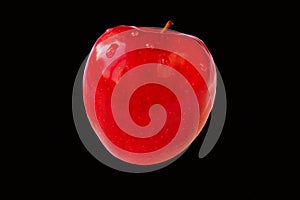 Ripe apple on a black background close-up, front view