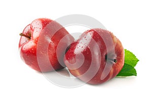 Ripe apple with a leaf on a white.