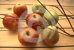 Ripe apples and pears on a rustic table.