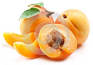 Ripe apricots with apricot leaf isolated on the white background