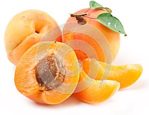 Ripe apricots with apricot leaf isolated on the white background