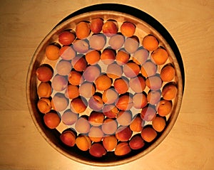 Ripe apricots from France in a wooden dish