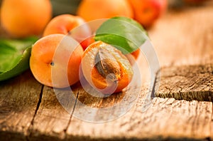 Ripe apricots on a wooden background