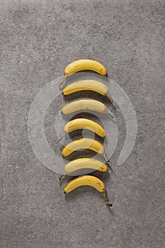 Ripe bananas on gray concrete background. Interior photo. photoArt. top view
