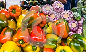 Ripe beautiful vegetables, onions, peppers, cucumber on the counter in the market