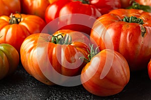 Ripe Beefsteak Tomatoes on rustic black table