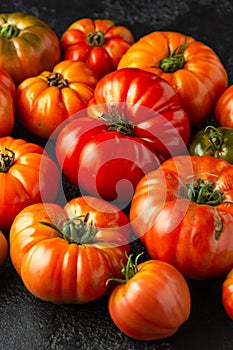 Ripe Beefsteak Tomatoes on rustic black table
