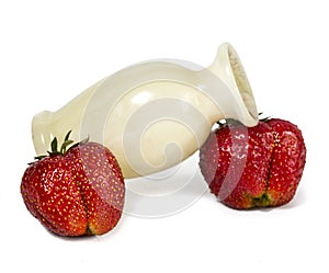 Ripe berries of strawberry and vase from onyx on a white background