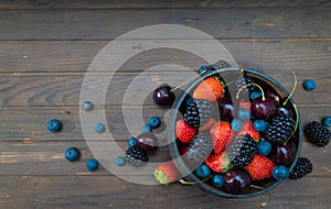 Ripe berries in the wooden bowl