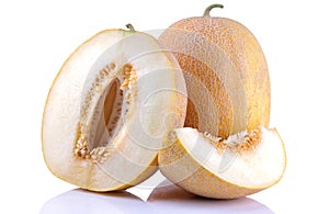 ripe big melon and a slice of melon on a white isolated background. Fruit. close-up