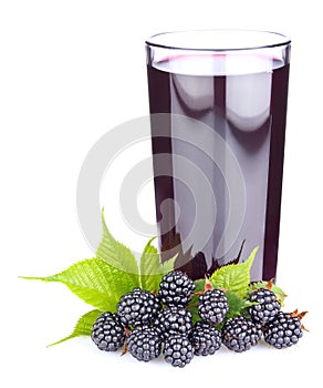 Ripe blackberry with green leaves and fresh juice in glass