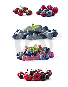 Ripe blueberries, blackberries, blackcurrants, strawberries, raspberries, gooseberries and red currants isolated on white. Mix fru
