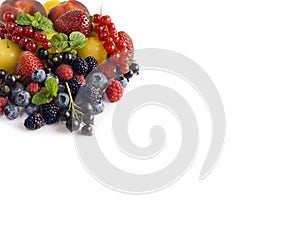 Ripe blueberries, raspberries, black currants, red currants, blackberries, strawberries, yellow plums and peaches on white backgr