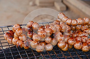 Ripe brown pall sausages on old grille for sale