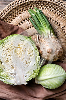 Ripe cabbage and celery on wicker plate
