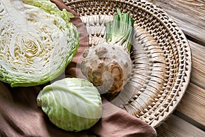 Ripe cabbage and celery on wicker plate
