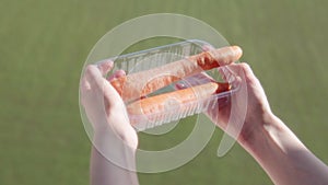 Ripe carrots in the hands of a successful farmer on a white background, close-up.